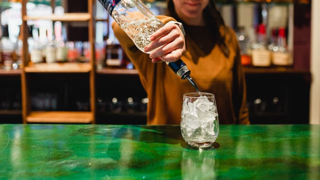 Things to do in Stillwater, bartender pouring a drink at Charlie's Irish Pub in the Water Street Inn 