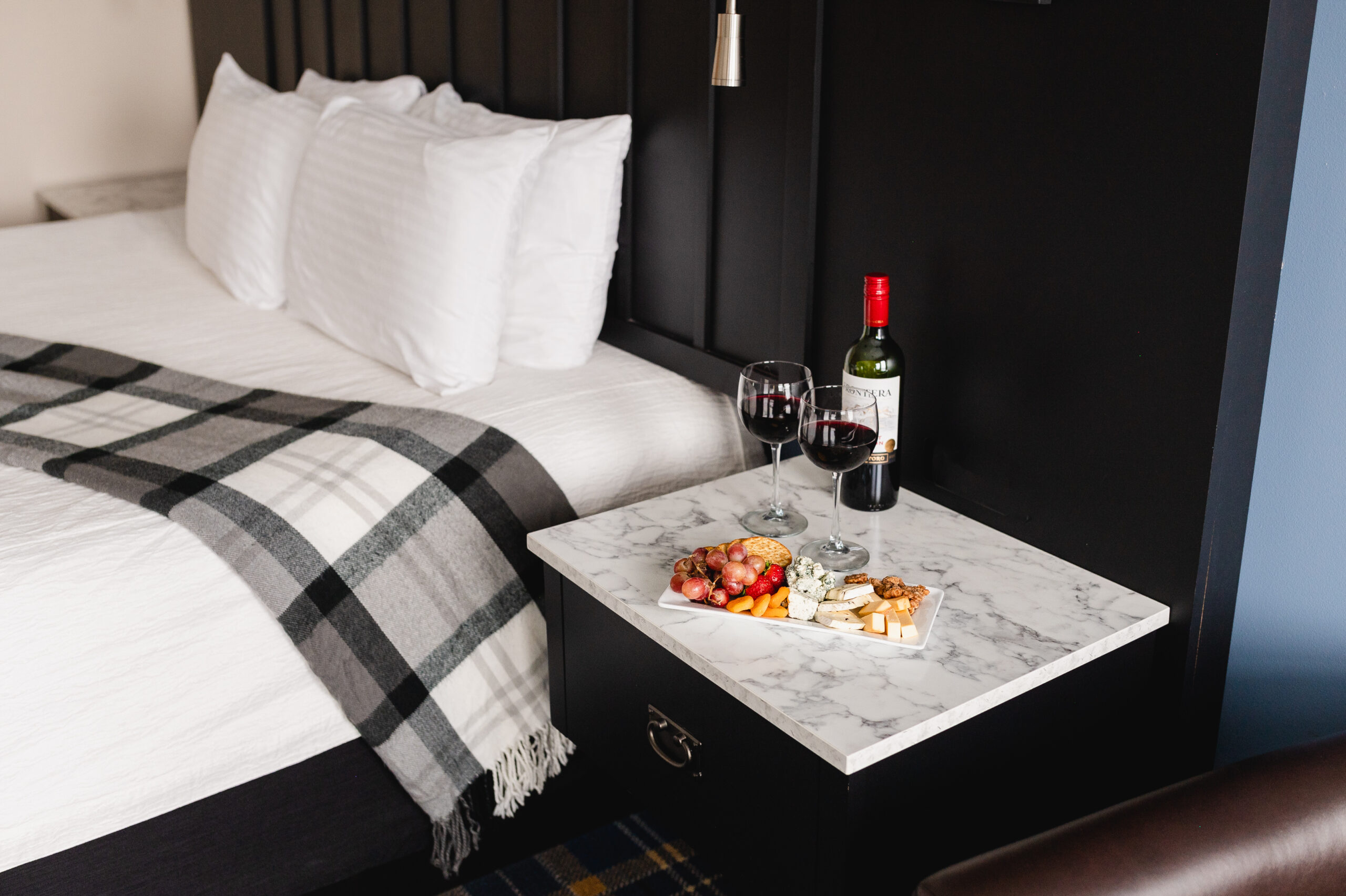a room and charcuterie board at our Stillwater Hotel.